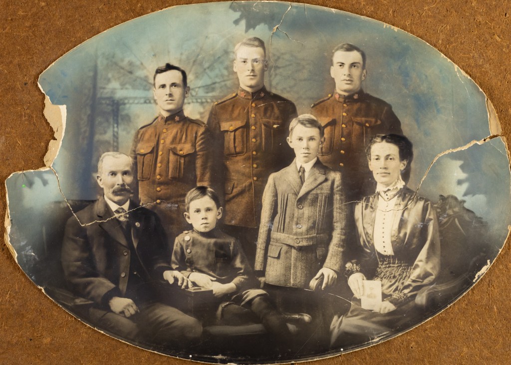 Repaired vintage family photograph,  restored faded details and torn edges. By Walcott Studio, Columbus, WI, appointments 414-418-2593.